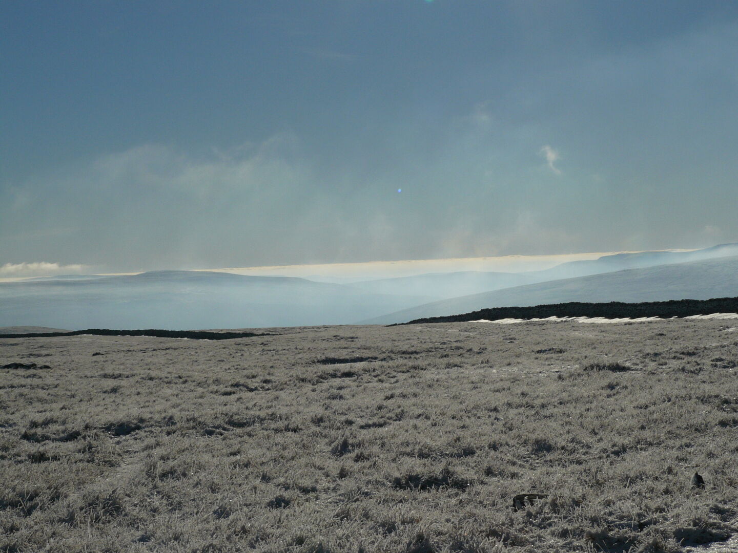 Clouds only peep over the mountains at the horizon today.