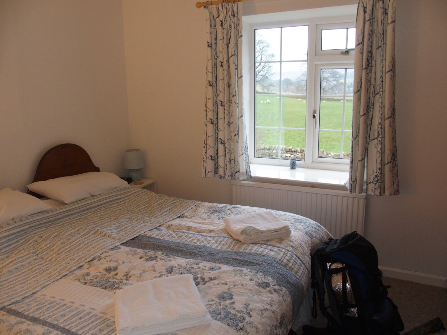 Our room in Holmhead guest house, and the view from the lounge: Thirlwall castle and sheep.