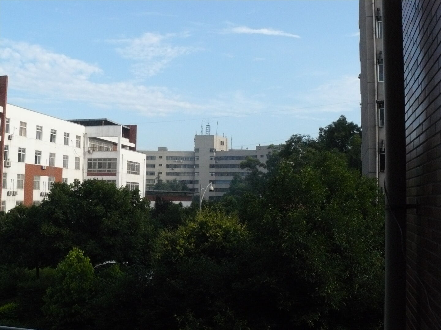 View from my bedroom. Perhaps you can see the cable wound around the gutter --- that&rsquo;s the internet cable which is connected to the DSL router. I live on the second floor of the building.